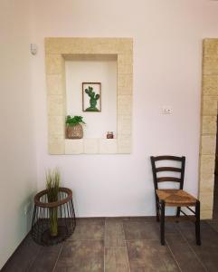 a living room with two chairs and a wall at Tenuta Fascianello in Fasano