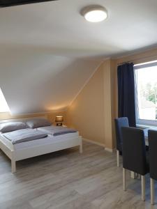1 dormitorio con cama, mesa y ventana en Arielle, en Łazy