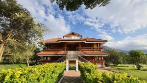 a large building with a staircase leading up to it at Avadale Masinagudi - Stag Groups Not Allowed in Masinagudi