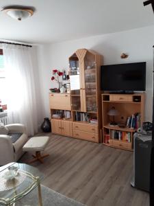 a living room with a flat screen tv and a couch at Ferienwohnung Hummer im Haus Daheim in Helgoland