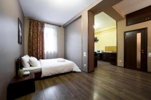 Postel nebo postele na pokoji v ubytování Aparthotel Na Mytniy