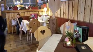 un restaurante con una mesa con corazones de madera. en Gasthaus Dollinger en Dinkelsbühl