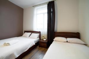 Postel nebo postele na pokoji v ubytování Aparthotel Na Mytniy