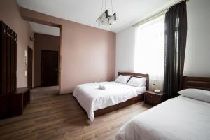 Postel nebo postele na pokoji v ubytování Aparthotel Na Mytniy