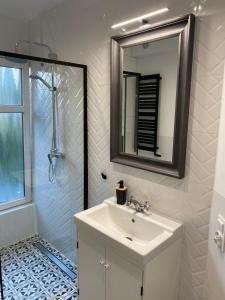a bathroom with a sink and a mirror and a shower at Przystań w Pucku in Puck +25 photos