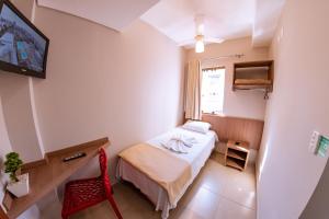 A bed or beds in a room at Hotel Ipiranga Maringa