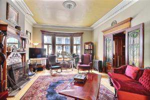 a living room with a red couch and a fireplace at B&B Quebec in Quebec City