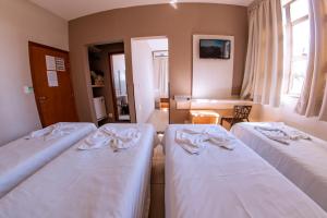 Cama ou camas em um quarto em Hotel Ipiranga Maringa