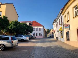 a street in a town with cars parked on the street at Apartmány Žižkova in Česká Lípa
