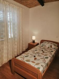 a bedroom with a bed and a window at House Haler in Krnica