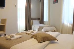 a hotel room with two beds with towels on them at Hotel Casa calda in Kutaisi
