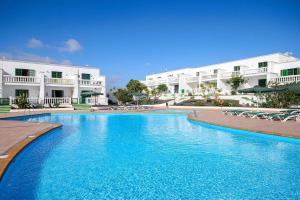 a large swimming pool in front of a building at Buenavista Ocean View in Puerto del Carmen
