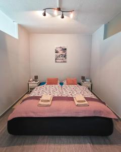 a bedroom with a large bed with two towels on it at Solarberg Apartment in Andermatt