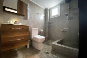 a bathroom with a toilet and a sink and a tub at Green apartment with view in Komotini +24 photos