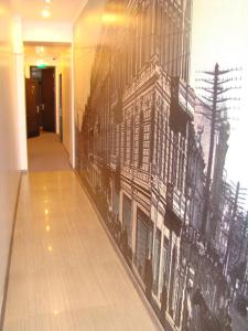 a mural of a building on a wall in a hallway at StanGret Hotel in Kyiv