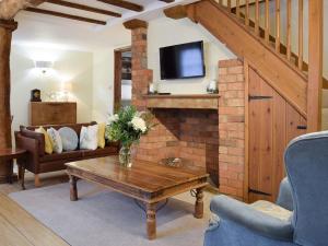 a living room with a couch and a table at Lovely old cottage in Stratford-upon-Avon +8 photos