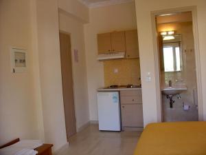 a kitchen with a white refrigerator and a sink at Akti Studios in Nydri