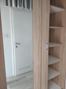 a closet with a white door and shelves at Botanical garden in Zagreb