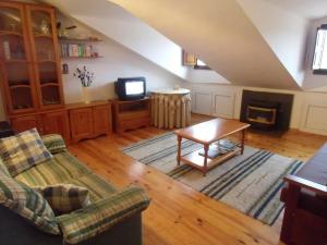 a living room with a couch and a table at Apartamento Bielva in Bielva +15 photos