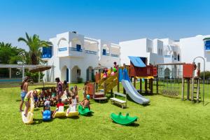 a group of people playing in a playground at The Mirage Resort & SPA in Hammamet