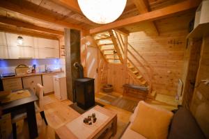a kitchen and living room of a log cabin at Villa RESET in Zlatibor