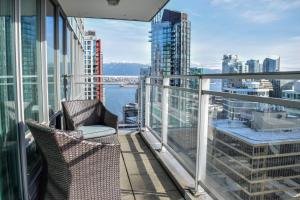 a balcony with chairs and a view of the city at Vancouver Extended Stay in Vancouver