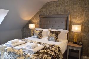a bedroom with a bed with towels on it at The Lord Street Hotel; BW Signature Collection in Southport