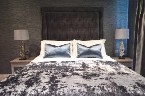 a bedroom with a large bed with three pillows at The Lord Street Hotel; BW Signature Collection in Southport