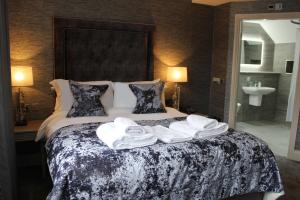 a hotel room with a bed with towels on it at The Lord Street Hotel; BW Signature Collection in Southport