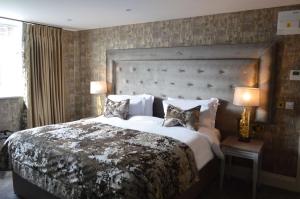 a bedroom with a large bed with two pillows at The Lord Street Hotel; BW Signature Collection in Southport