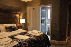 a bedroom with a bed with towels on it at The Lord Street Hotel; BW Signature Collection in Southport