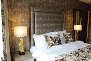 a bedroom with a white bed and two lamps at The Lord Street Hotel; BW Signature Collection in Southport