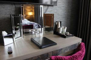 a desk with a laptop and a bed in a room at The Lord Street Hotel; BW Signature Collection in Southport