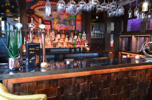 a bar with a lot of bottles of alcohol at The Lord Street Hotel; BW Signature Collection in Southport