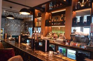 a bar with a counter with a lot of bottles at The Lord Street Hotel; BW Signature Collection in Southport