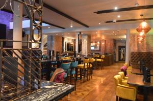 a restaurant with tables and chairs and a bar at The Lord Street Hotel; BW Signature Collection in Southport