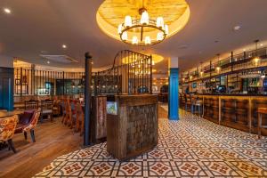 a bar in a restaurant with tables and chairs at The Bold Hotel; BW Signature Collection in Southport