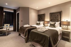 a hotel room with two beds and a window at The Bold Hotel; BW Signature Collection in Southport