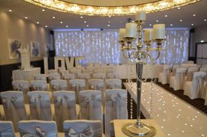 a set up for a wedding banquet with white chairs at The Bold Hotel; BW Signature Collection in Southport