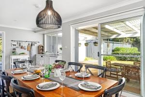 a kitchen and dining room with a wooden table and chairs at Lilyview Cottage - Robertson in Robertson