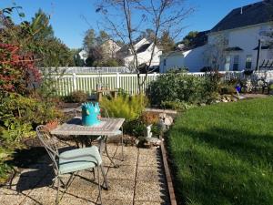 a patio table and chairs in a yard at Indys Hidden Gem in Indianapolis