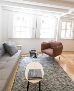 a living room with a couch and a chair at Souto Apartments in Porto