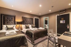 a hotel room with two beds and a mirror at The Bold Hotel; BW Signature Collection in Southport