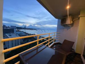 a balcony with a table and a chair on a building at View Talay6 Mark Apartments in Pattaya