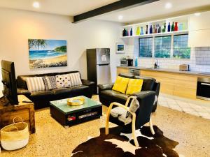 a living room with a couch and a table at Malibu Apartment - Peregian Beach in Peregian Beach