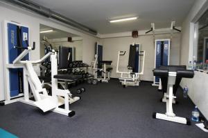 a gym with several treadmills and machines in a room at Šiauliu Krasto Medžiotojų Užeiga in Šiauliai