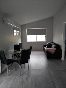 a living room with a couch and a table at Ashley's Retreat Umina Beach in Umina