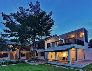 a rendering of a house with a tree at Hotel AONO in Chiang Mai