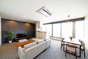 a living room with a couch and a table at STAY & GO Shinsaibashi-Kita in Osaka