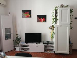 ein Wohnzimmer mit einem TV auf einem weißen Schrank in der Unterkunft Casa Diego in Cagliari